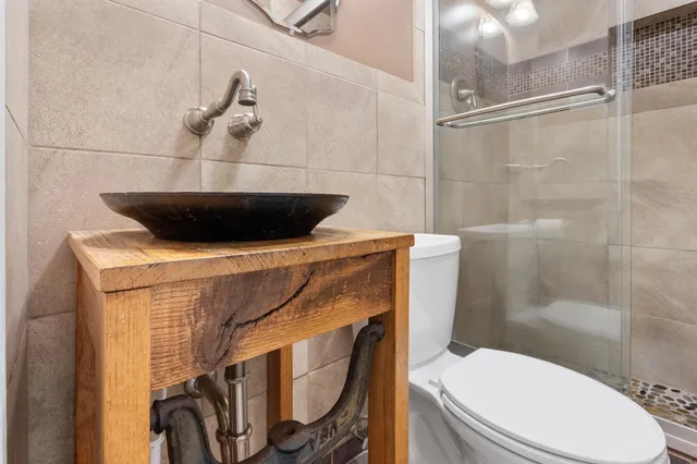a bathroom with a toilet a sink and shower