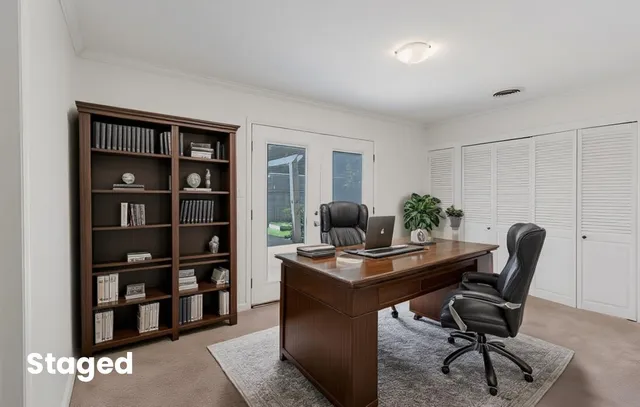 a view of a workspace with a bookshelf