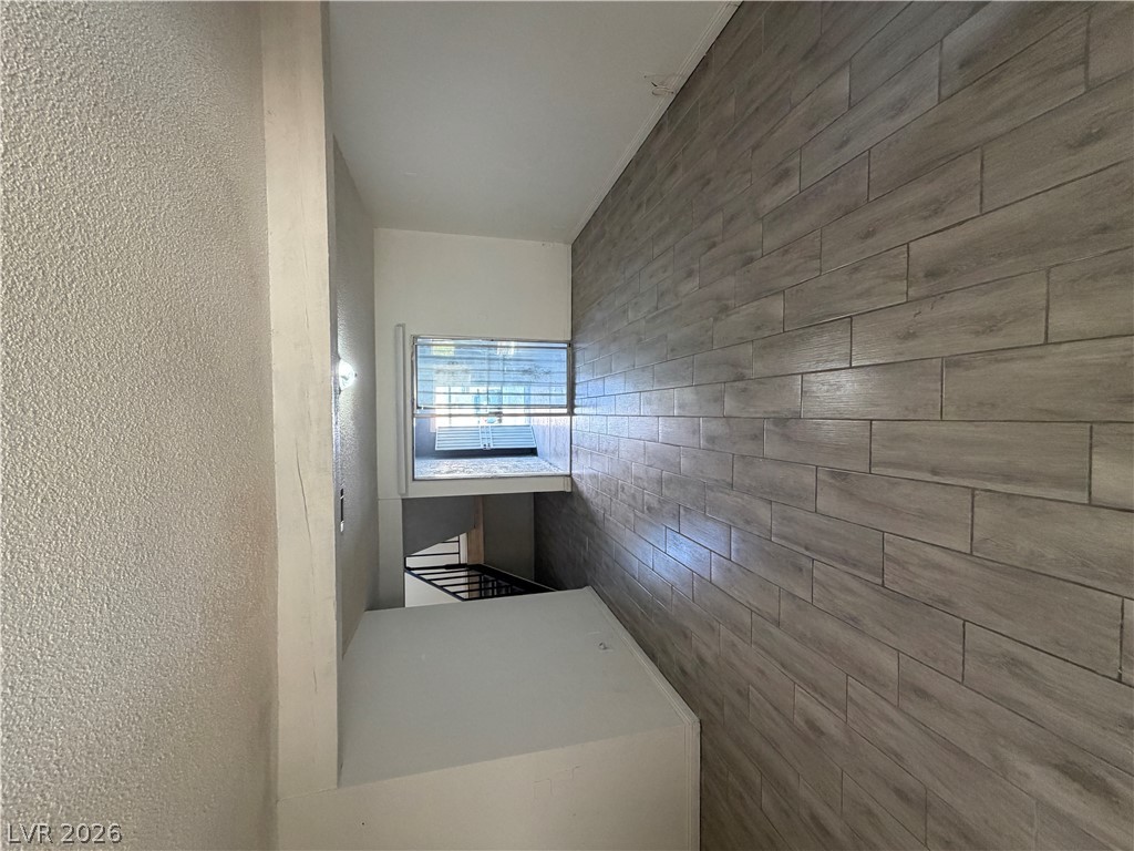 2236 East Desert Inn Road Las Vegas, NV 89169 - Photo 4 of 34 Textured walls meet a chic wood-look tile accent wall in this contemporary interior space.