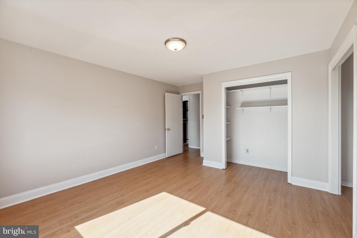 5101 8th Road South, Unit 310 Arlington, VA 22204 - Photo 20 of 28 an empty room with wooden floor and closet