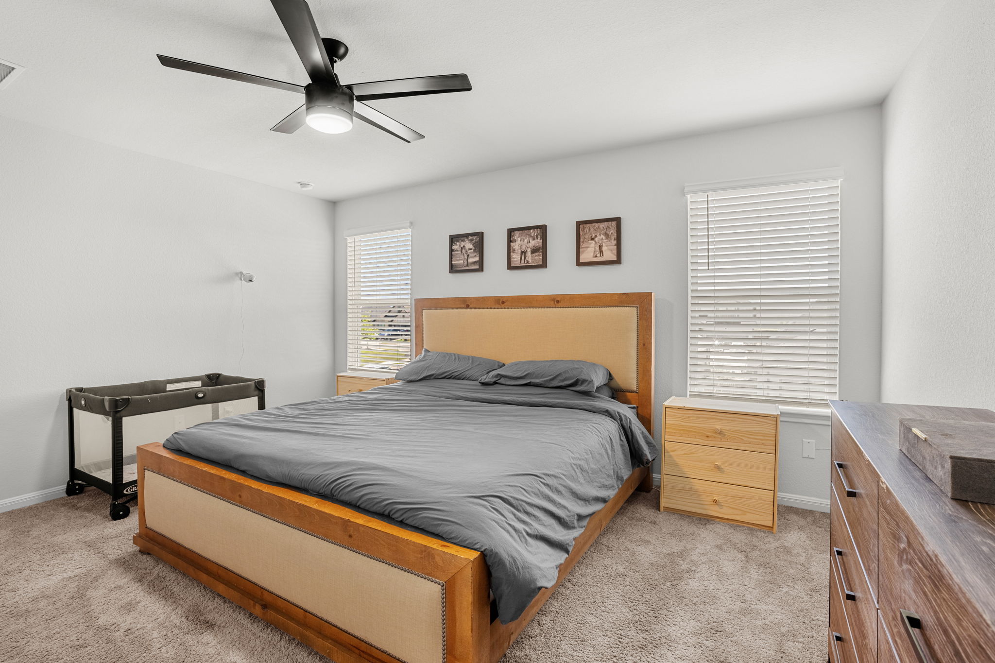 148 Hidalgo Lane Elgin, TX 78621 - Photo 22 of 38 Well-lit sleeping quarters with a functional ceiling fan, offering a comfortable personal retreat.