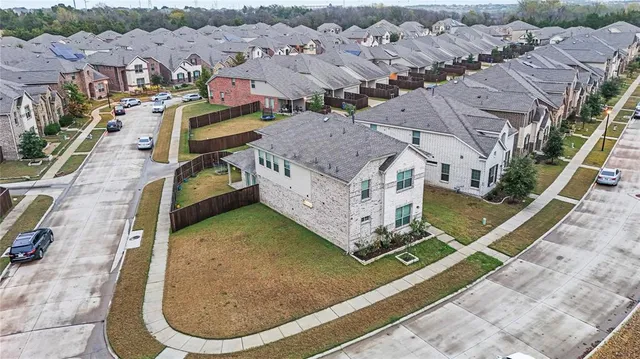 an aerial view of residential houses with outdoor space