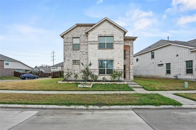 a front view of a house with a yard