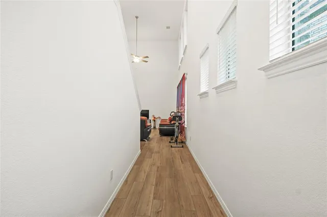 a view of a bedroom with wooden floor