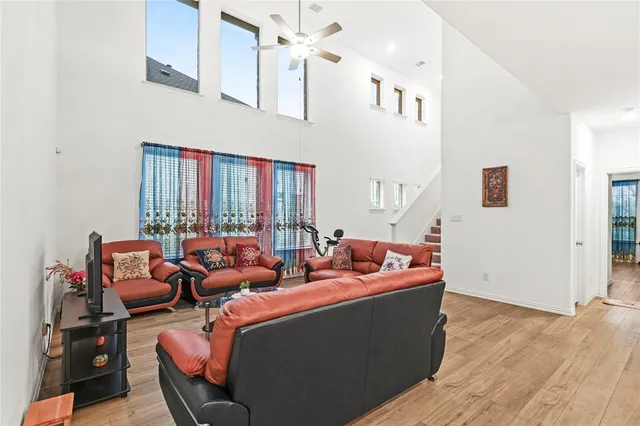 a living room with furniture kitchen view and a window