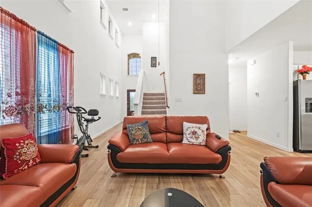 a living room with furniture and wooden floor
