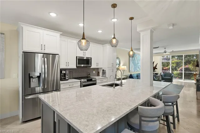 a kitchen with a table chairs refrigerator and microwave