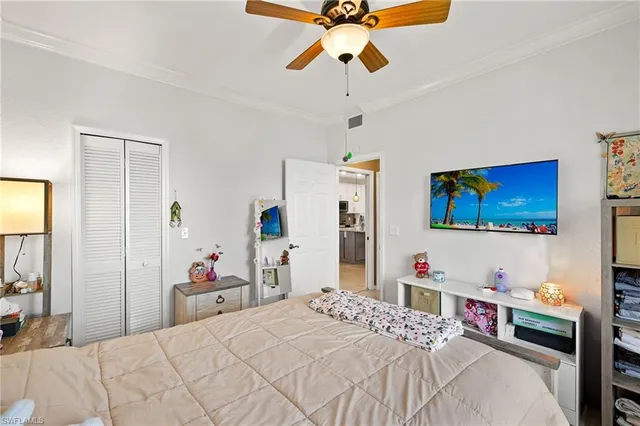 a bedroom with a bed and a large window