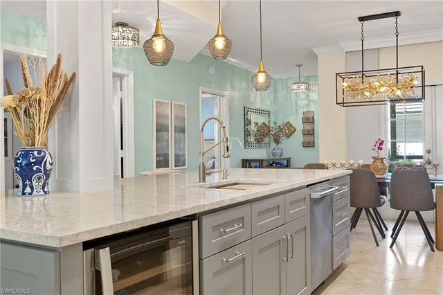 a kitchen with stainless steel appliances granite countertop a sink and a refrigerator