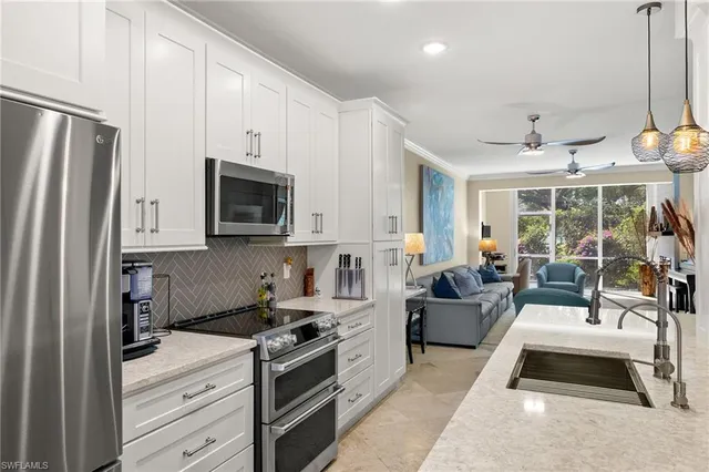 a white house with a yard and potted plants