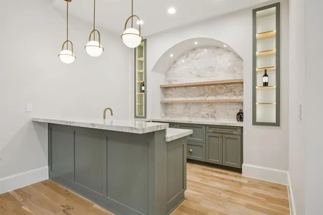 a kitchen with stainless steel appliances granite countertop a sink and dishwasher with wooden floor