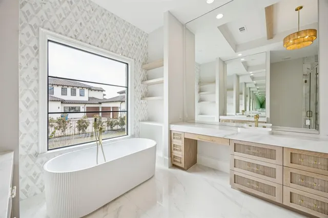 a spacious bathroom with a granite countertop tub sink and mirror