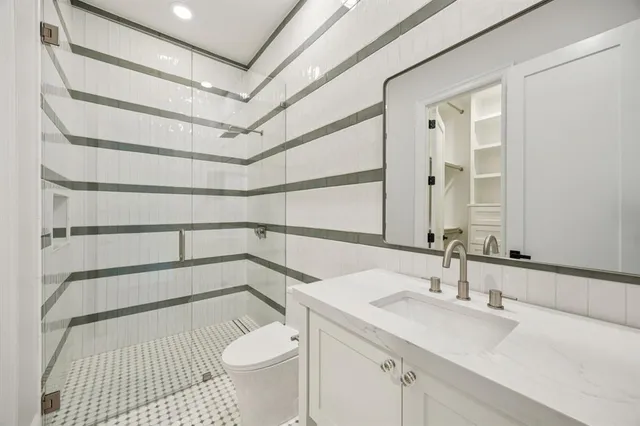 a bathroom with a sink toilet and shower