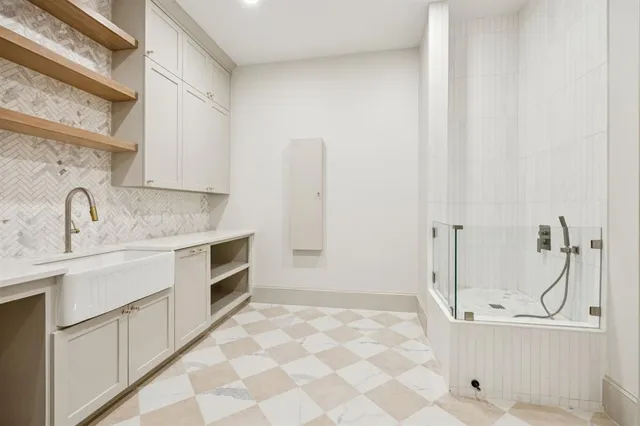 a bathroom with a sink toilet and shower