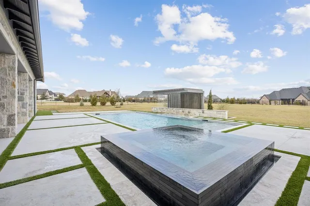a view of a swimming pool with a lounge chairs