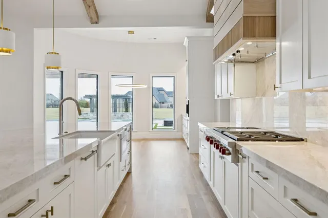 a kitchen with granite countertop a stove and a sink