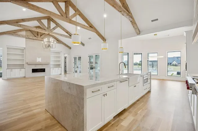 a large white kitchen with a large window