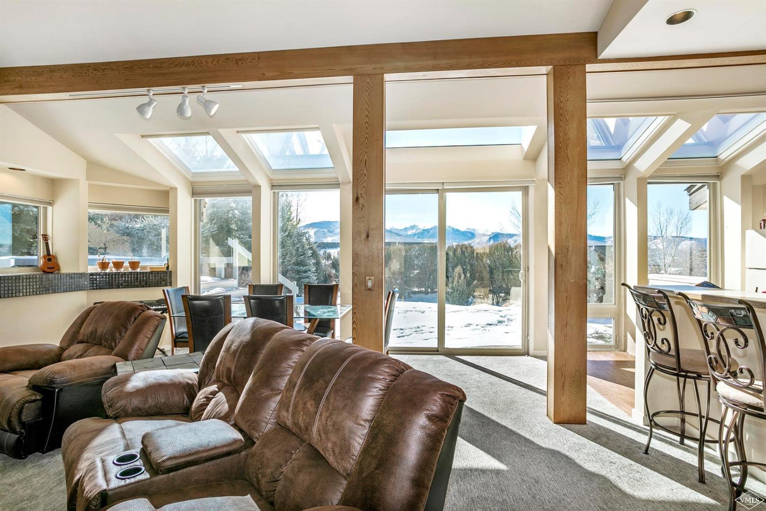 2613 Bear Trap Road Avon, CO 81620 - Photo 16 of 25 a living room with furniture and a floor to ceiling window
