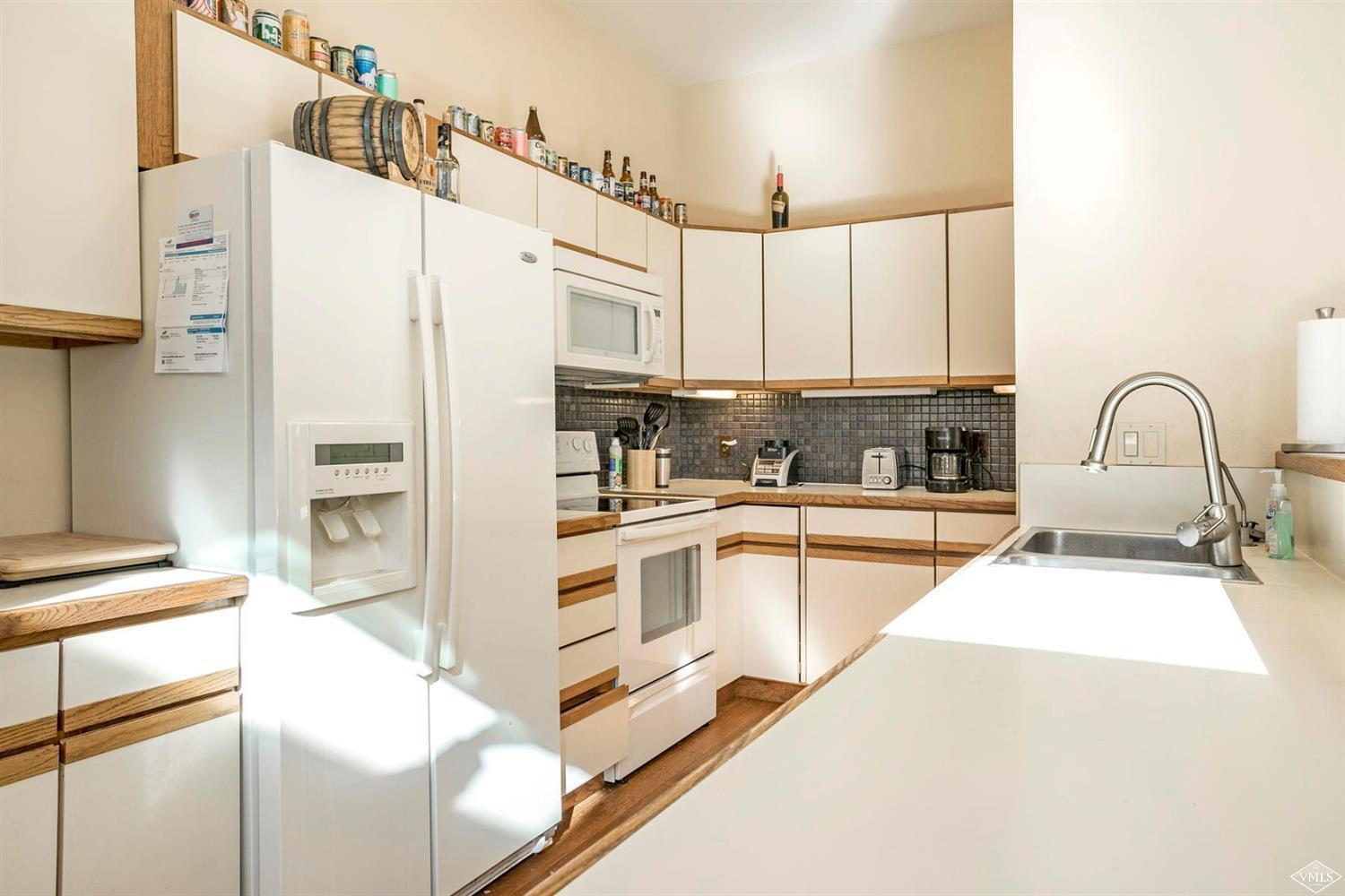 2613 Bear Trap Road Avon, CO 81620 - Photo 17 of 25 a kitchen with stainless steel appliances a refrigerator sink and cabinets