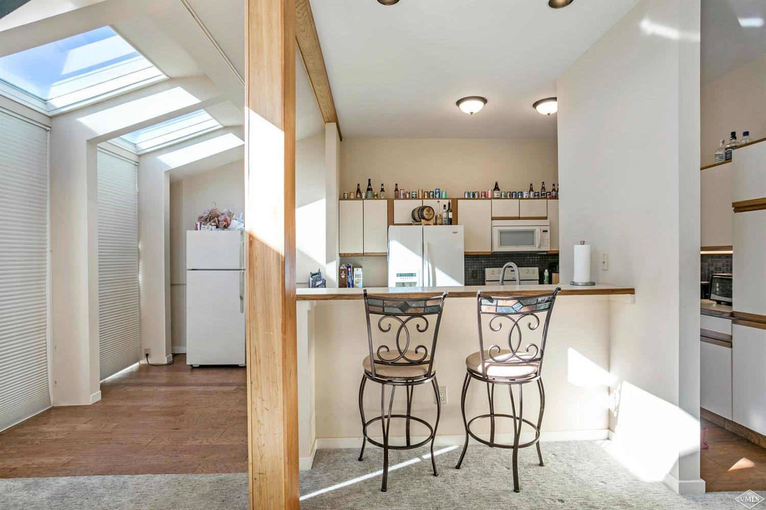 2613 Bear Trap Road Avon, CO 81620 - Photo 18 of 25 a kitchen with stainless steel appliances kitchen island granite countertop a refrigerator and cabinets
