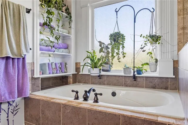 a bathroom with a bathtub sink and mirror