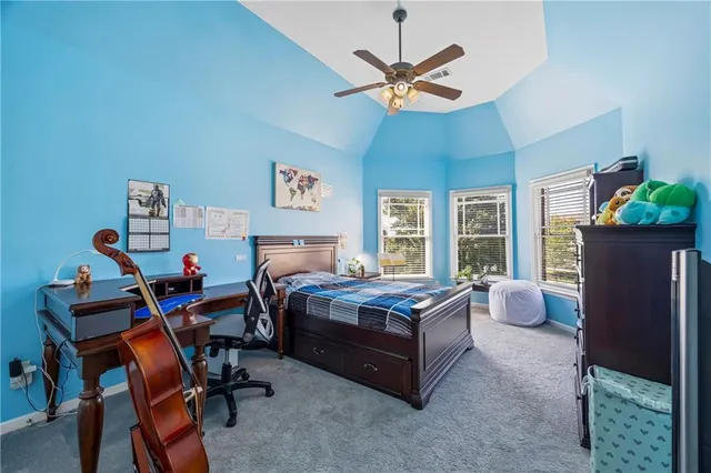 a bedroom with a bed and a dresser in it