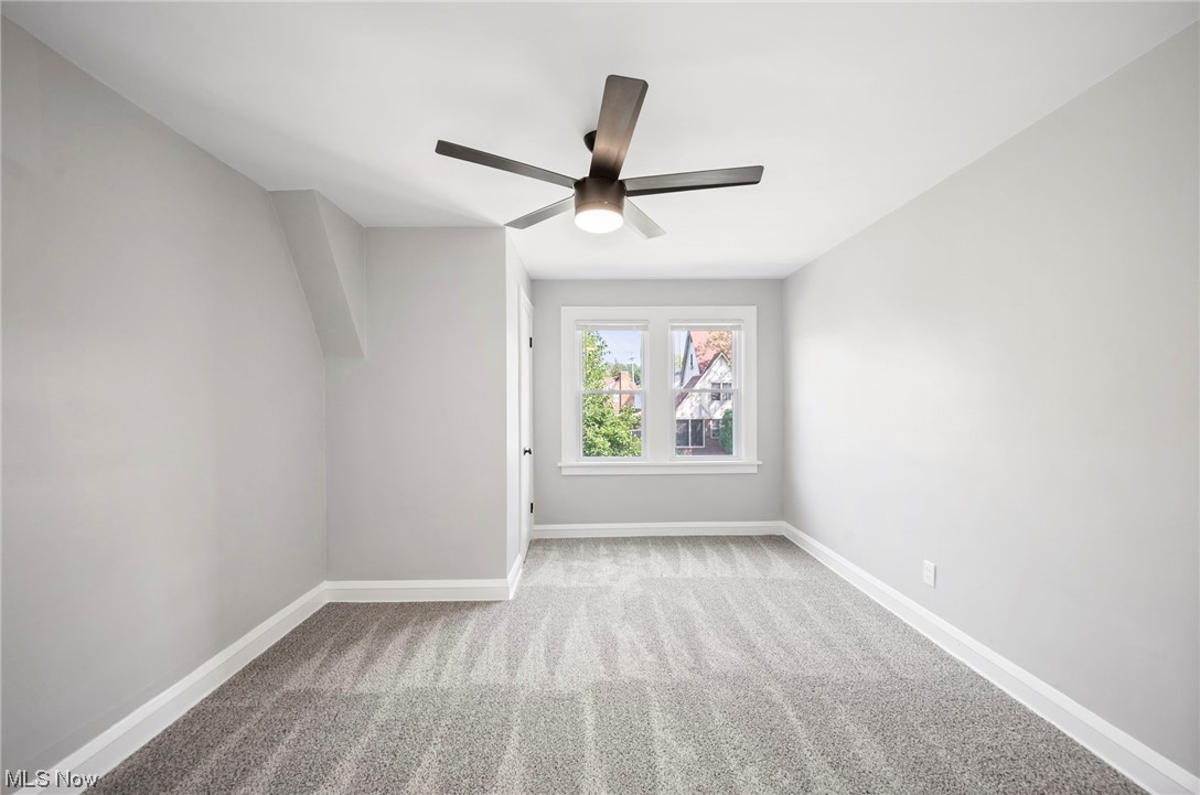 1022 Englewood Road Cleveland, OH 44121 - Photo 25 of 33 Empty room with light colored carpet and ceiling fan