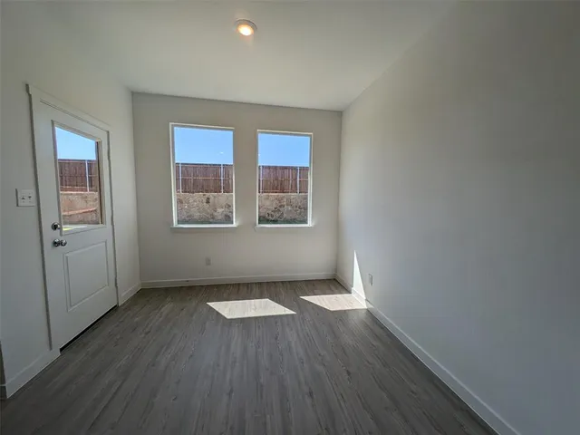 a kitchen with stainless steel appliances granite countertop a stove a sink and white cabinets