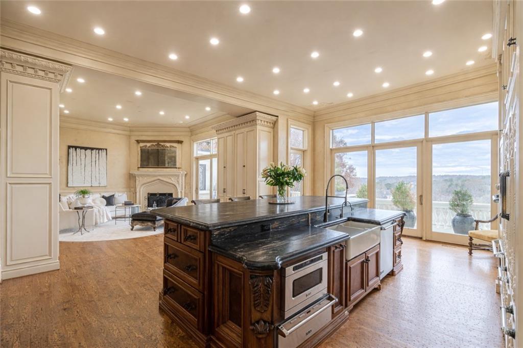 8330 Jett Ferry Road Sandy Springs, GA 30350 - Photo 12 of 98 a open kitchen with stainless steel appliances granite countertop a large center island and a large window