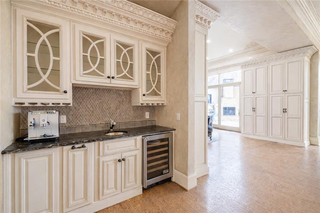 8330 Jett Ferry Road Sandy Springs, GA 30350 - Photo 16 of 98 a kitchen with stainless steel appliances granite countertop a sink and cabinets with wooden floor