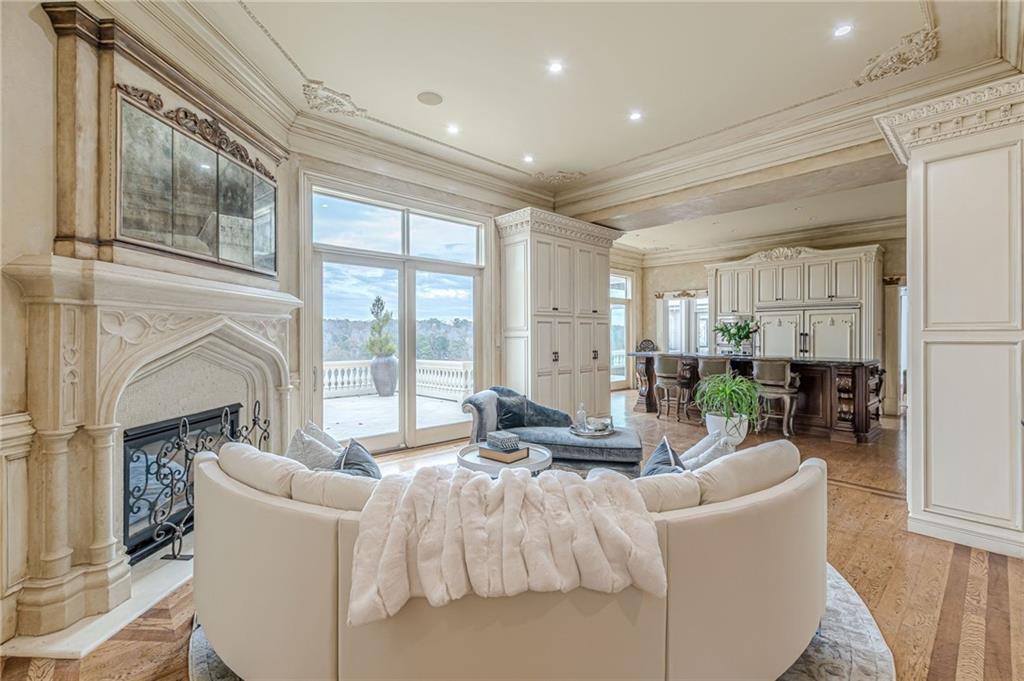 8330 Jett Ferry Road Sandy Springs, GA 30350 - Photo 18 of 98 a living room with furniture a fireplace and a floor to ceiling window