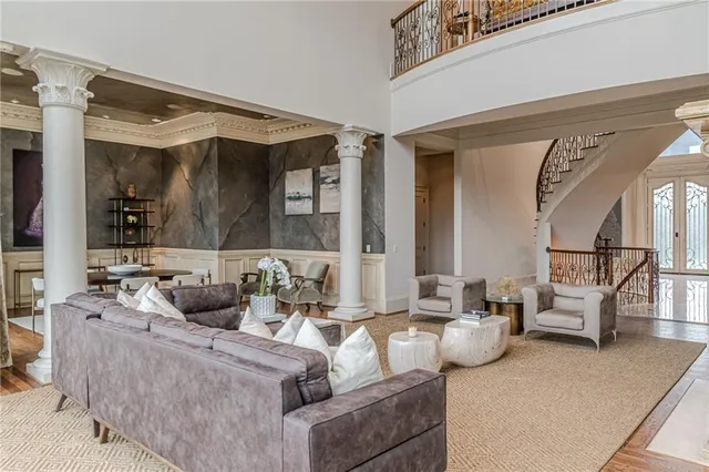 a view of a hallway with wooden floor and stairs
