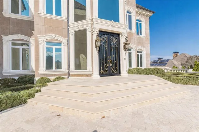 a view of a dining room with furniture and chandelier