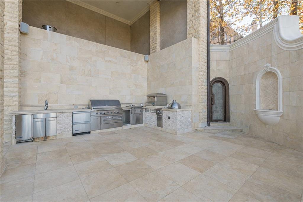 8330 Jett Ferry Road Sandy Springs, GA 30350 - Photo 86 of 98 a large bathroom with a double vanity sink a mirror and a bathtub