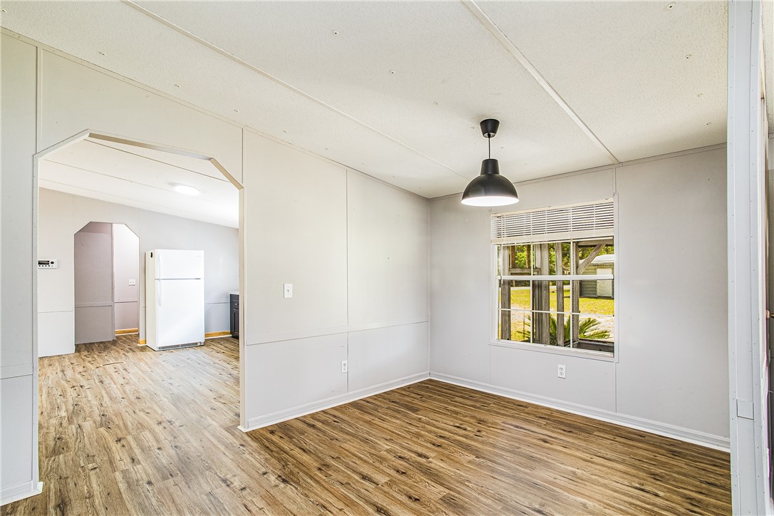 35157 Goodbread Road Callahan, FL 32011 - Photo 14 of 34 a view of an empty room with window and wooden floor