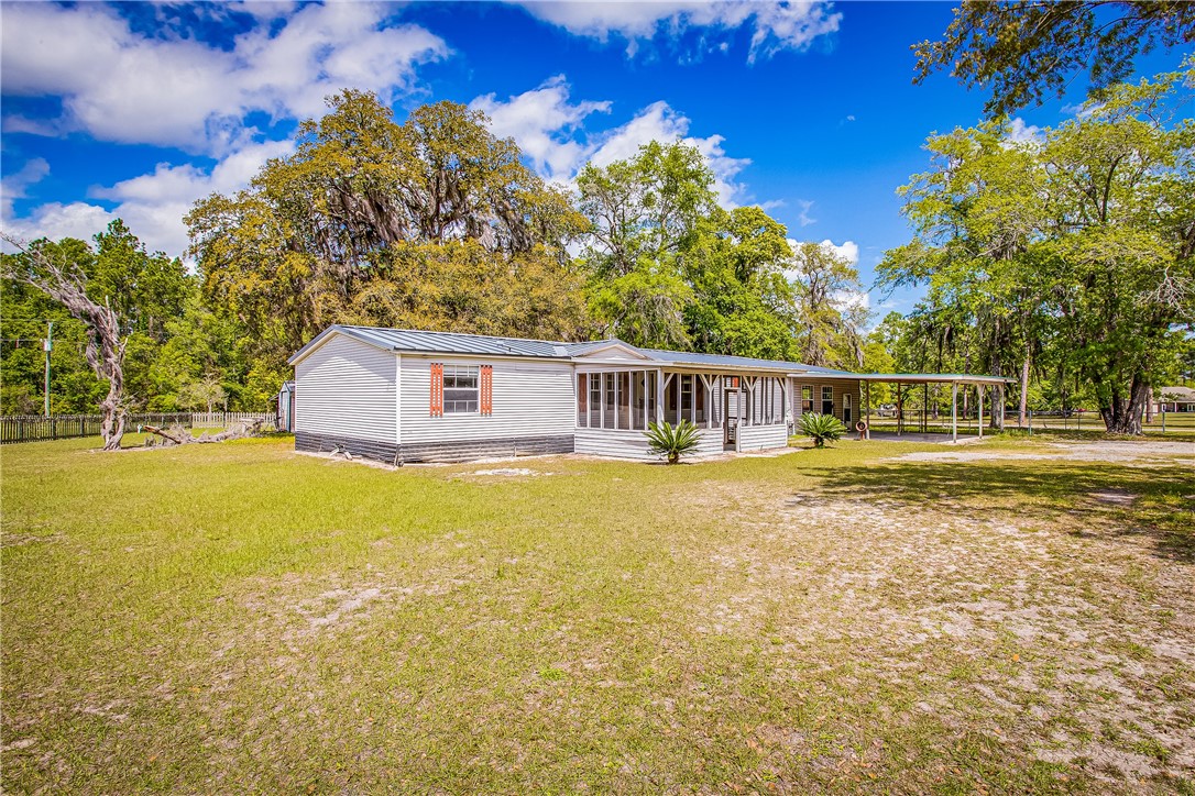 35157 Goodbread Road Callahan, FL 32011 - Photo 2 of 34 a front view of a house with a garden