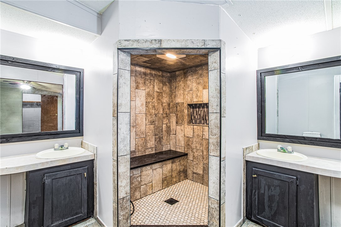 35157 Goodbread Road Callahan, FL 32011 - Photo 21 of 34 a bathroom with a sink a mirror and a shower