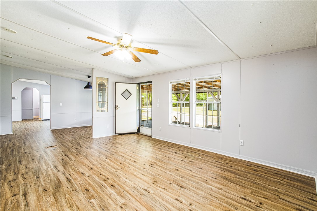 35157 Goodbread Road Callahan, FL 32011 - Photo 7 of 34 a view of empty room with wooden floor and fan