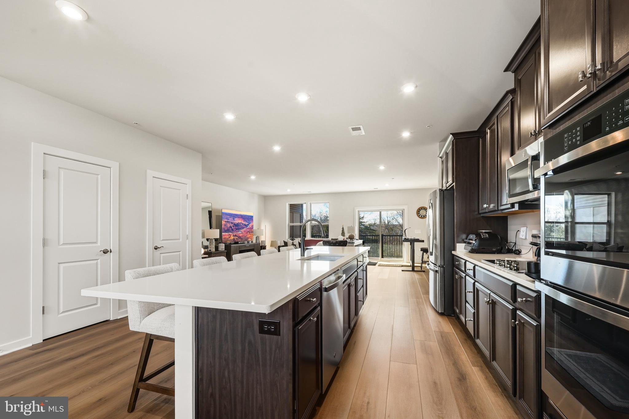 13508 INNOVATION Sta Loop, Unit 3B Herndon, VA 20171 - Photo 9 of 28 a kitchen with counter top space a sink appliances and cabinets