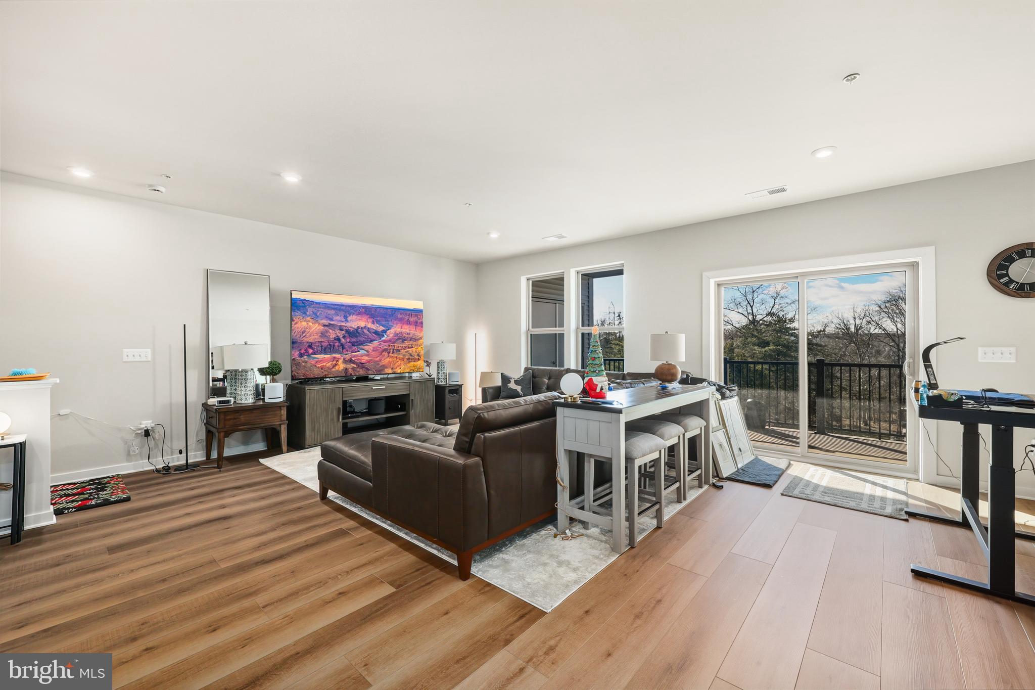 13508 INNOVATION Sta Loop, Unit 3B Herndon, VA 20171 - Photo 27 of 28 a living room with furniture a flat screen tv and wooden floor