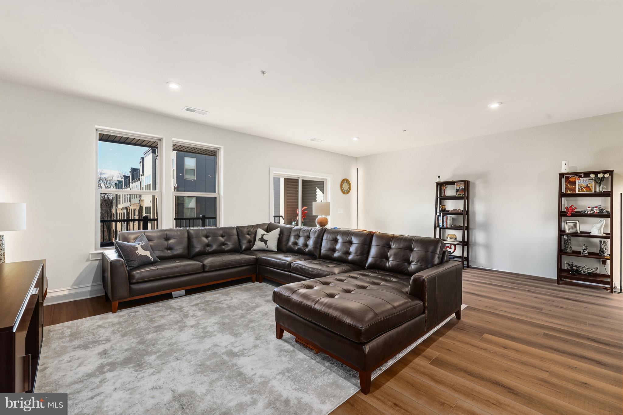 13508 INNOVATION Sta Loop, Unit 3B Herndon, VA 20171 - Photo 5 of 28 a living room with furniture and a wooden floor