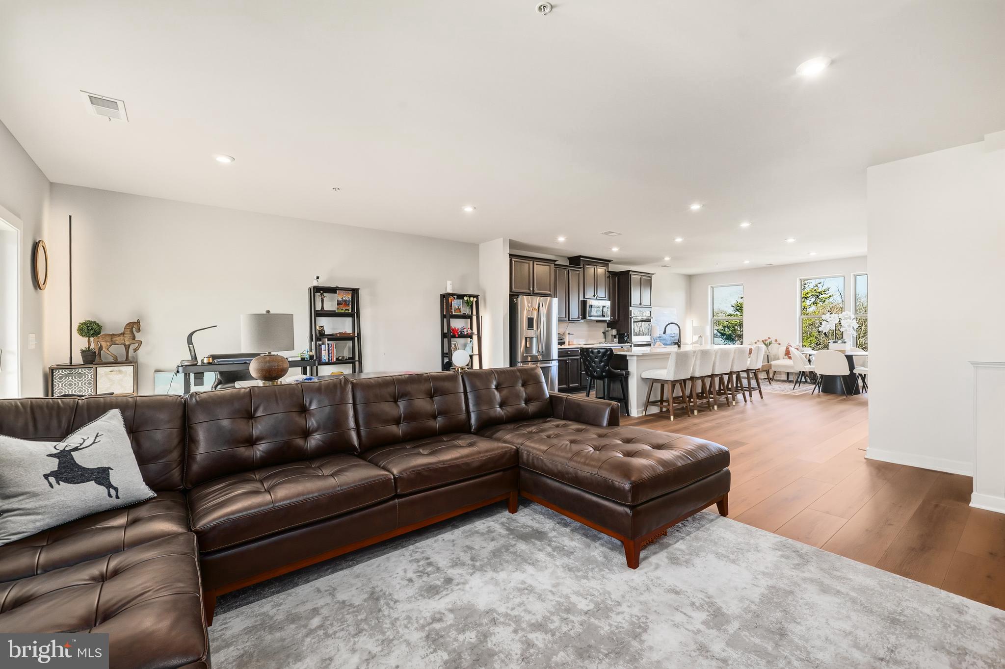 13508 INNOVATION Sta Loop, Unit 3B Herndon, VA 20171 - Photo 6 of 28 a living room with furniture or kitchen view and a wooden floor