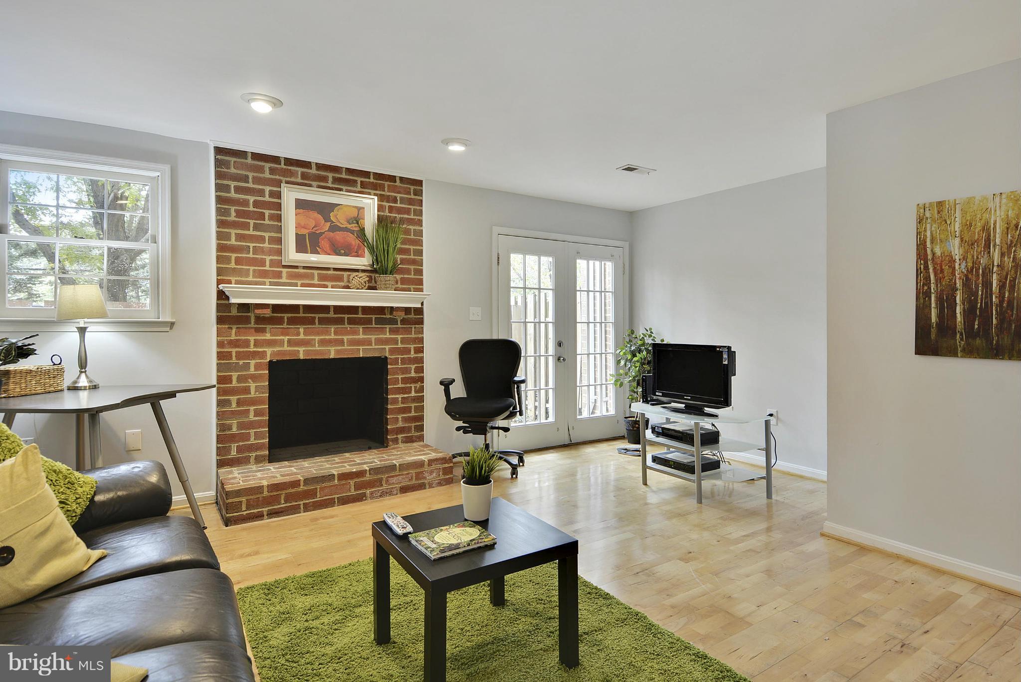 2059 South Glebe Road Arlington, VA 22206 - Photo 11 of 20 a living room with furniture a fireplace and a flat screen tv