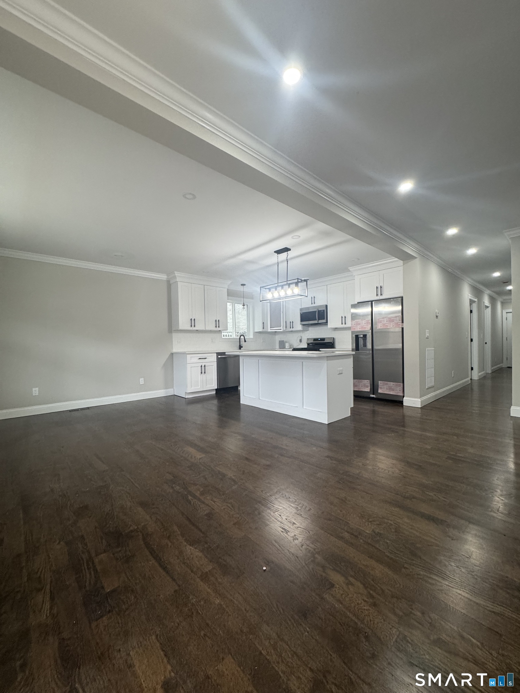 279 Harriet Street Bridgeport, CT 06608 - Photo 3 of 9 a view of a kitchen with a sink and wooden floor