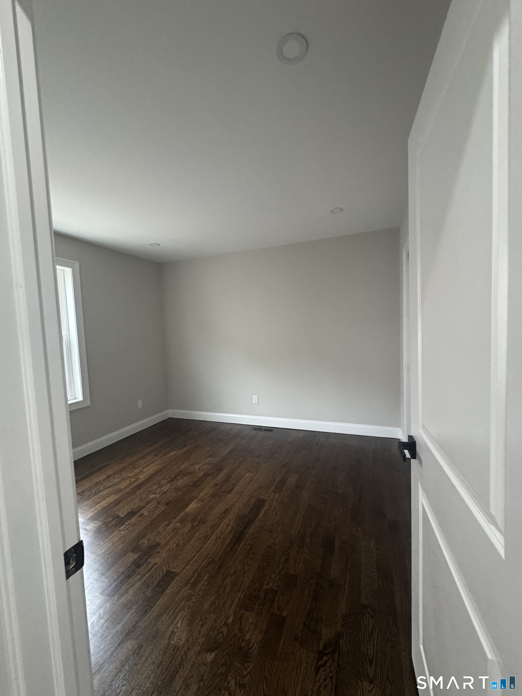 279 Harriet Street Bridgeport, CT 06608 - Photo 7 of 9 a view of an empty room and wooden floor