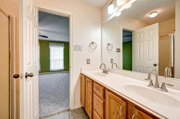 a bathroom with a sink double vanity and a mirror