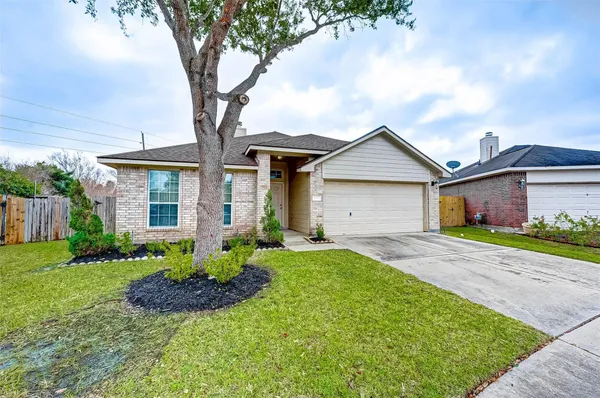 a front view of a house with a garden and yard