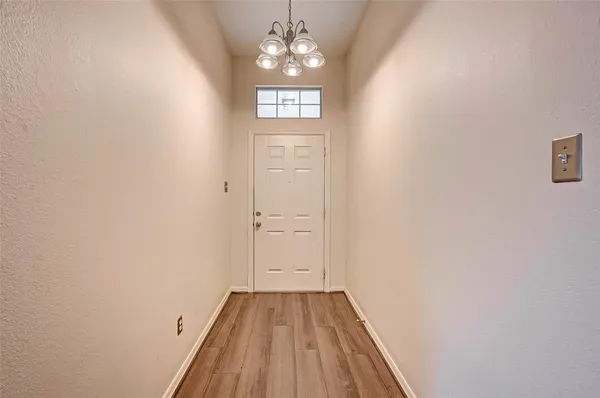 a view of an entryway with wooden floor