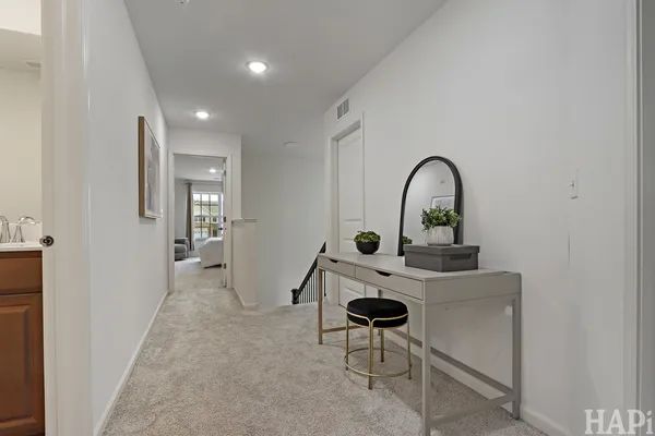 a living room with furniture a rug and white walls