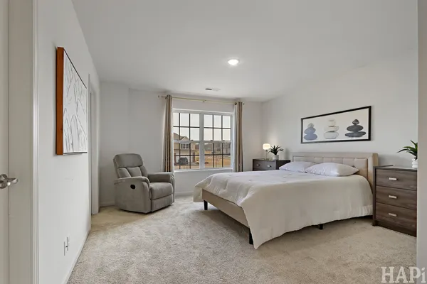 a spacious bedroom with a bed and glass window